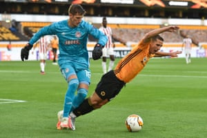 Olympiacos keeper Bobby Allain (left) fouls Wolverhampton’s Daniel Podence and gives away a penalty.