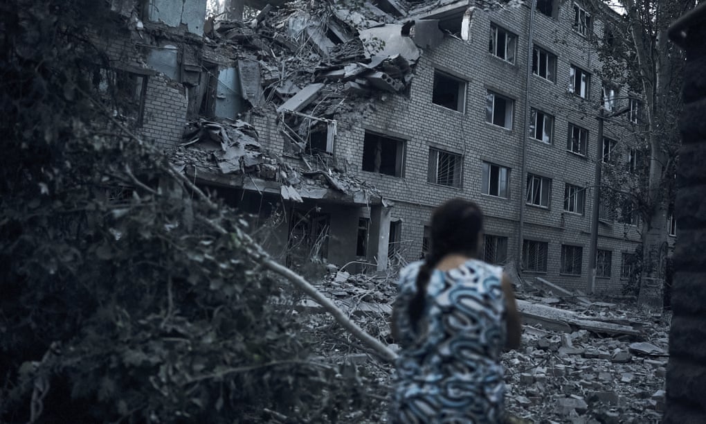 A woman walks near a damaged block of flats after shelling in Mykolaiv, southern Ukraine, this week
