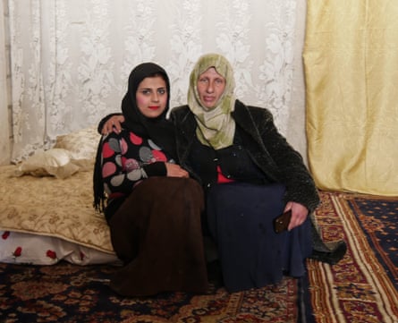 Umm Mohammed and her new 13-year-old daughter-in-law, on the marital bed she put together for the couple.