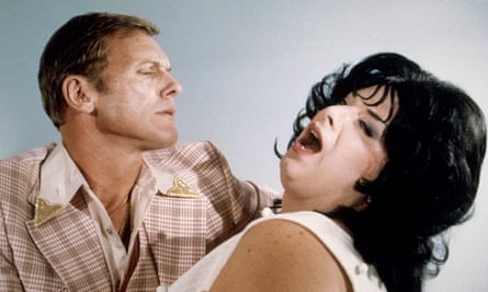 A man holds a swooning woman