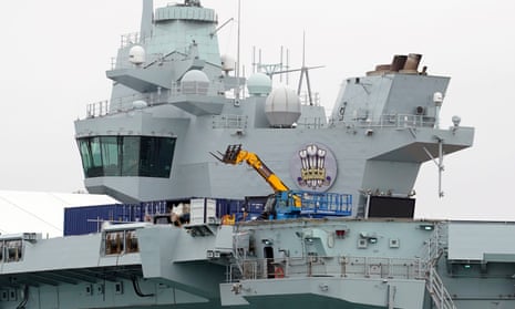 Work is undertaken on the flight deck of the HMS Prince of Wales.