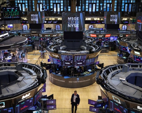 A trader walks on the trading floor at the New York Stock Exchange (NYSE) in Manhattan, New York City, U.S., August 3, 2022. REUTERS/Andrew Kelly