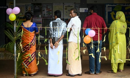 People queue to cast their vote at a polling station during the second phase of voting of India’s general elections in Wayanad district in Kerala on 26 April