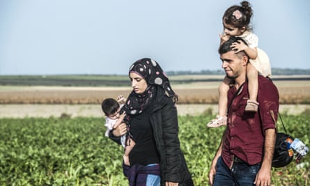 A refugee family walk through Serbia towards towards the Croatian border.