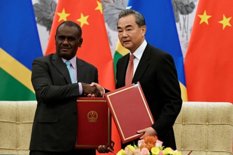 Solomon Islands foreign minister Jeremiah Manele (L) shakes hands with Chinese foreign minister Wang Yi in Beijing, 2019.