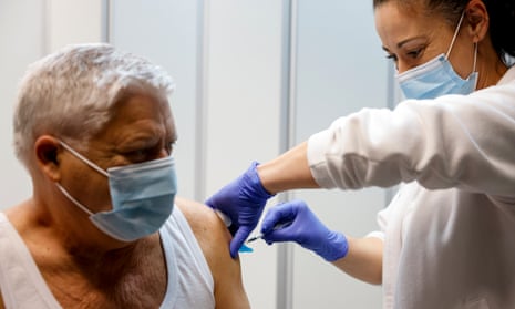 A man gets the flu vaccine administered at a health centre