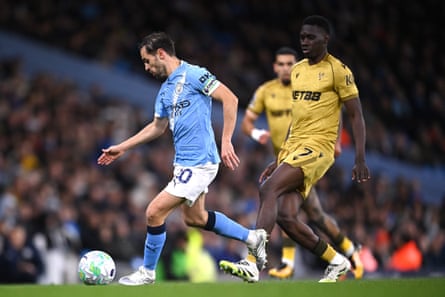Bernardo Silva of Manchester City is tracked by Ismaïla Sarr