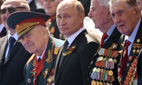 Vladimir Putin watches a parade in Moscow