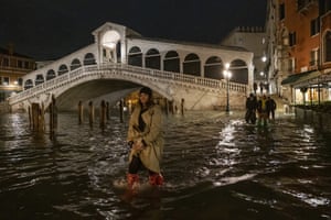 A tourist walks near the Rialto bridge