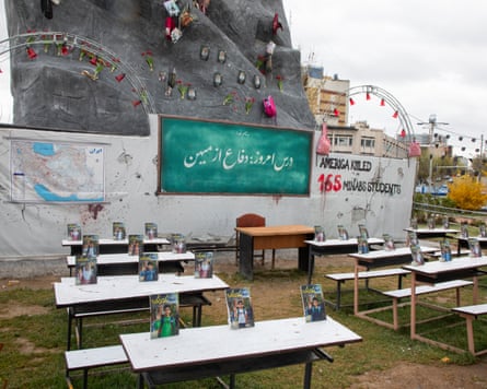 Desks with portraits on them outside
