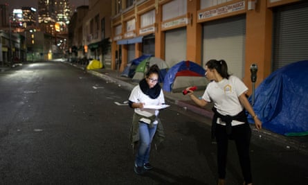 Volunteers count homeless people on a dark street in Skid Row, during the 2015 Greater Los Angeles homeless count.