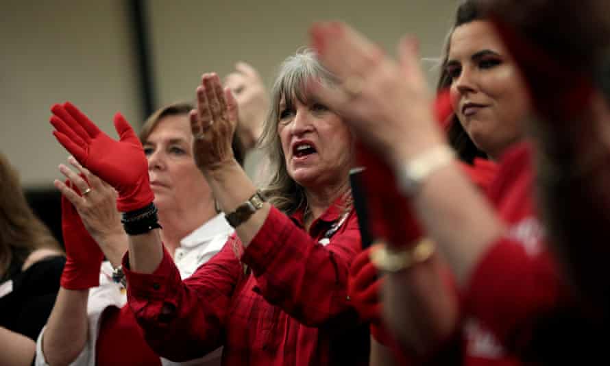 Supporters of Senator Ted Cruz applaud wearing 'Red Wave' gloves at a campaign rally in Victoria, Texas, on 3 November.