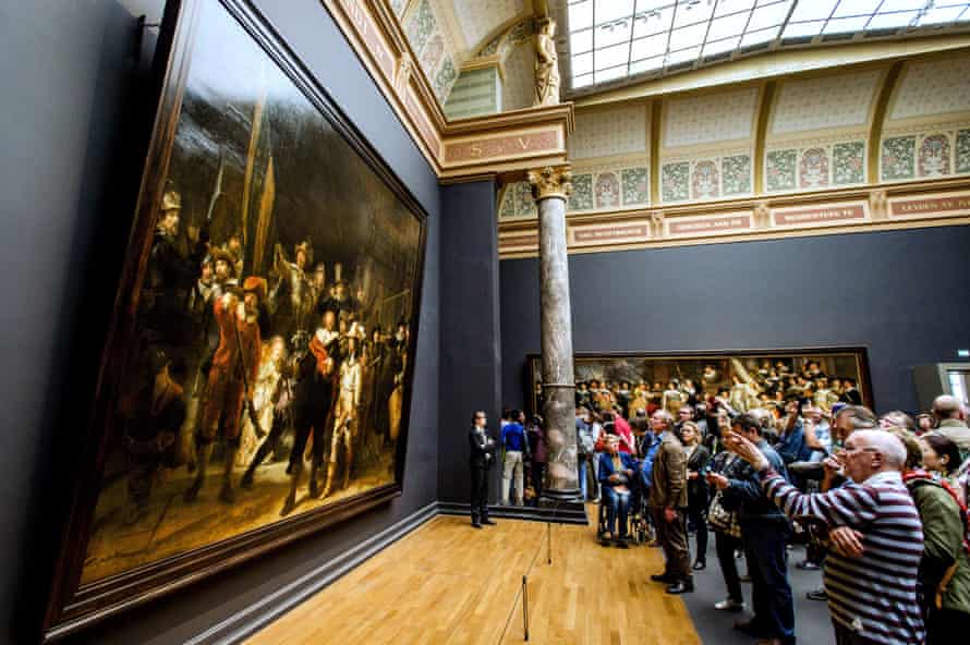 Visitors looks at Rembrandt’s the Night Watch in the Rijksmuseum in Amsterdam.