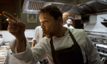 The chef is pointing his finger