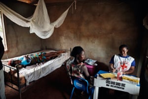 A health coordinator treats patient at a health post in Ekang village