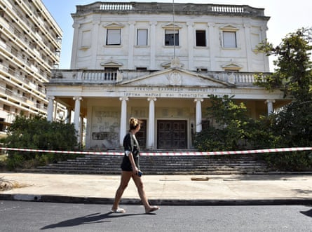 A woman walks past a cordoned-off building in Varosha.