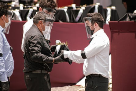 A man receives the ashes of a relative during the ceremony