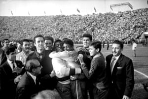 Pelé is pictured hugging Amarildo after Brazil’s 3-1 victory in the final against Czechoslovakia