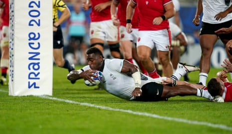 Fiji's Josua Tuisova scores their side's third try.