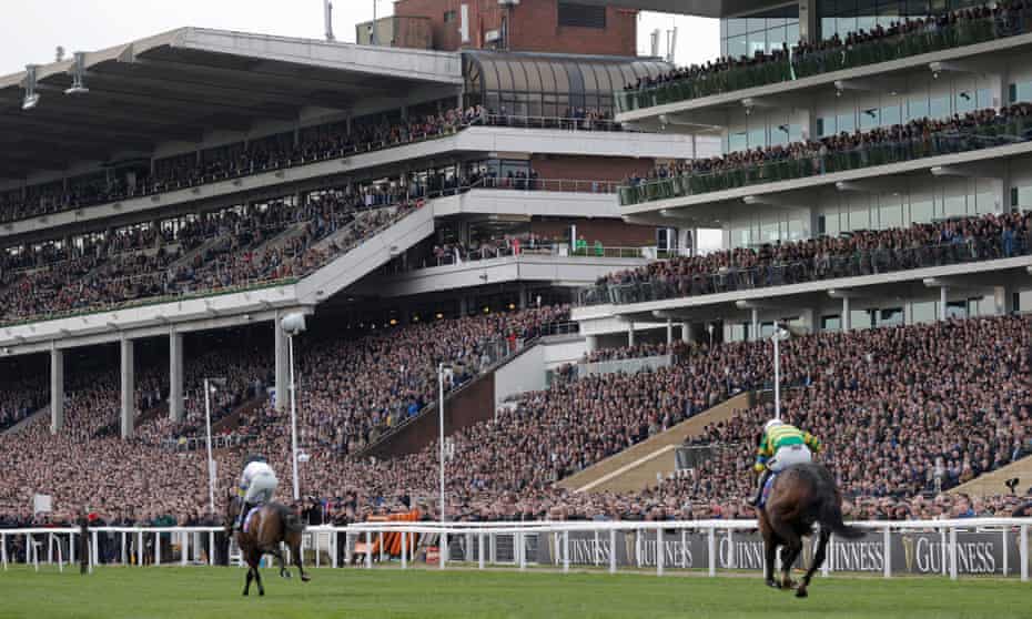 The packed stands watch as Constitution Hill races clear to win the first race of the Festival.