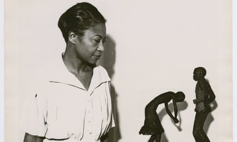 Augusta Savage viewing two of her sculptures, Susie Q and Truckin, 1939
