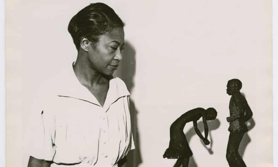 Augusta Savage viewing two of her sculptures, Susie Q and Truckin, 1939