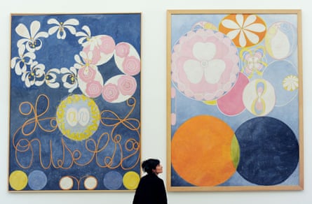 A woman views Hilma af Klint’s Group IV, The Ten Largest, 1907 at the Serpentine Gallery, London.