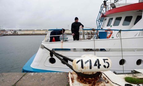 Fishers stand aboard a British trawler detained in Le Havre as it waits for permission to leave.