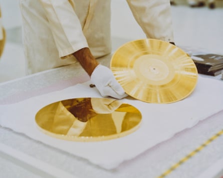 Two of the original Voyager Golden Records, circa 1977, being handled by white-gloved hands.