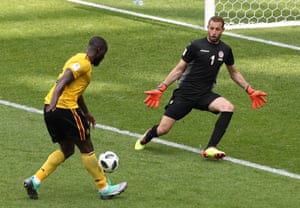 Romelu Lukaku chips his second goal past Farouk Ben Mustapha of Tunisia to join Cristiano Ronaldo at the top of the goalscoring charts.