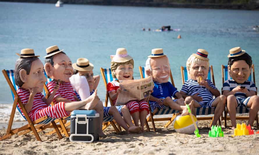 Oxfam campaigners posed as G7 leaders on Swanpool Beach.