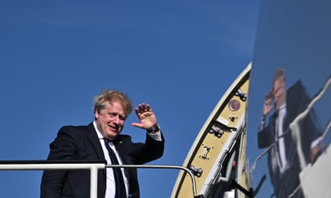 Boris Johnson boards a plane at Stansted Airport for a visit to India.