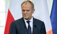 Donald Tusk with flags behind