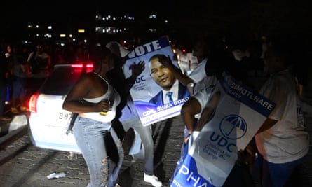 Umbrella for Democratic Change supporters cheer in the streets in Gaborone.