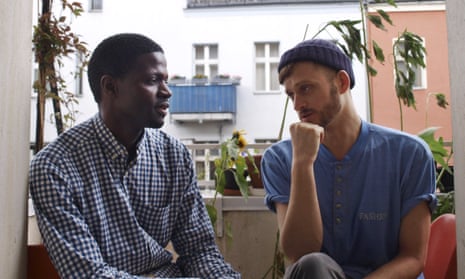 Jonas Kakoschke (right) and Bakary Conan chat at Kakoschke’s flat in Berlin. Kakoschke gave shelter to Conan with his initiative Refugees Welcome, which has now placed 26 refugees in private homes.