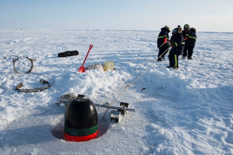 Civilian personnel from the US Navy’s Arctic Submarine Laboratory prepare to retrieve a torpedo fired under the ice by the USS Hartford, a nuclear attack submarine, during ice operations. Two other submarines, including a Royal Navy submarine from the United Kingdom, later sailed below the ice to the North Pole from a base set up on a floating ice sheet 150 miles north of Deadhorse, Alaska.