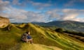 A hiker takes in the view in the Llangattock escarpment quarries looking towards Crickhowell, Wales.