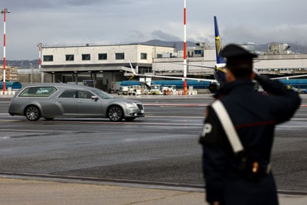 Officer salutes as the coffin of Riccardo Minghetti arrives in Italy