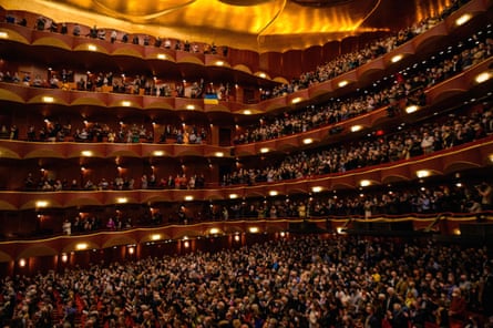 Members of the audience hold a Ukrainian flag during the benefit “Concert for Ukraine” held at the Metropolitan Opera, New York in March 2022.