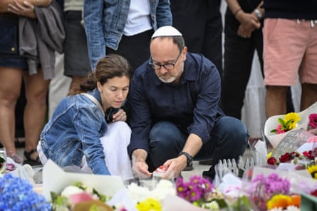 Mourners lay flowers at Bondi on Monday.