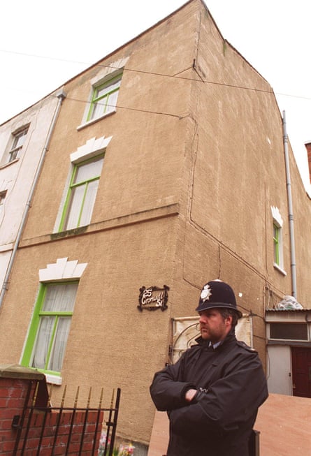 The outside of 25 Cromwell Street, the house in Gloucester where serial killers Fred and Rose West murdered and buried their victims, with a police officer standing guard