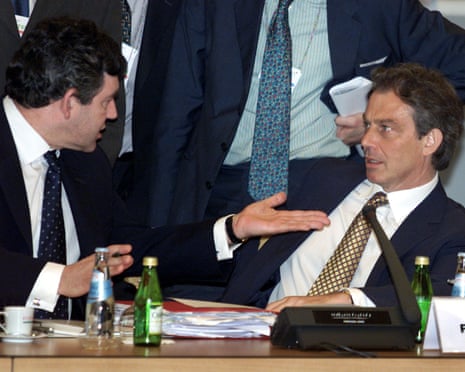 Tony Blair leans backwards as Gordon Brown talks to him in 2000.