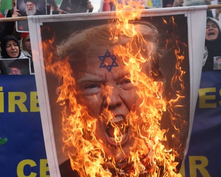 An effigy of Donald Trump is set alight during a protest in Istanbul.