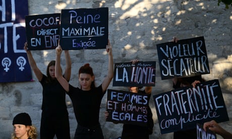 Demonstrators hold placards during a during the trial of a man accused of drugging his wife for nearly ten years and inviting strangers to rape her at their home.