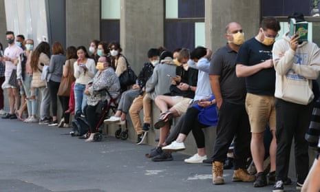 A queue of people wait for testing outside Royal Melbourne Hospital