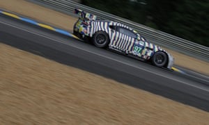 Boasting a special Le Mans livery the Aston Martin “Art Car” catches the eye of spectators.