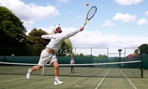 Tennis coach Phil Spencer and the nine-year-old club member Gigi Welch at the Bowdon Lawn Tennis Club on Wednesday.