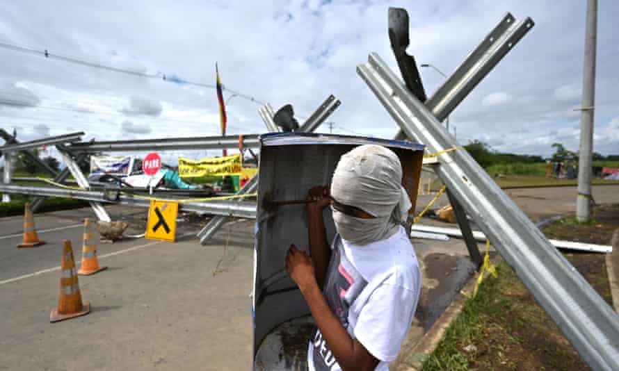 CA demonstrator holds a makeshift shield near a barricade blocking the Panamerican highway in Cali, Colombia, on Monday.