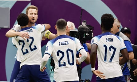 Harry Kane celebrates his equalizer against France with his England teammates.