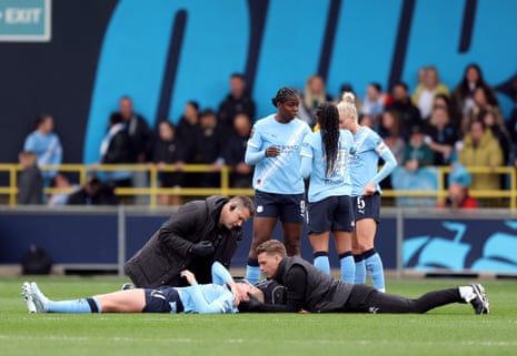Rebecca Knaak of Manchester City receives medical treatment